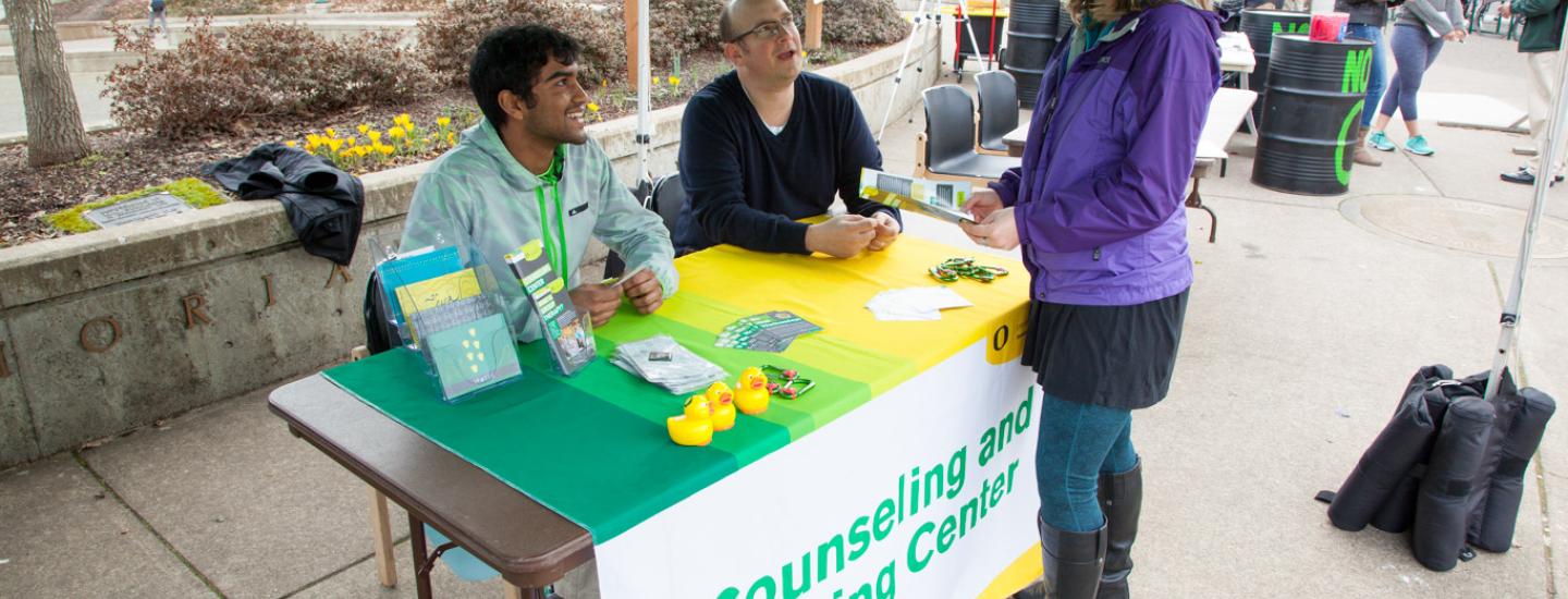 Counseling center staff table in front of the Erb Memorial Union Counseling center staff table in front of the Erb Memorial Union